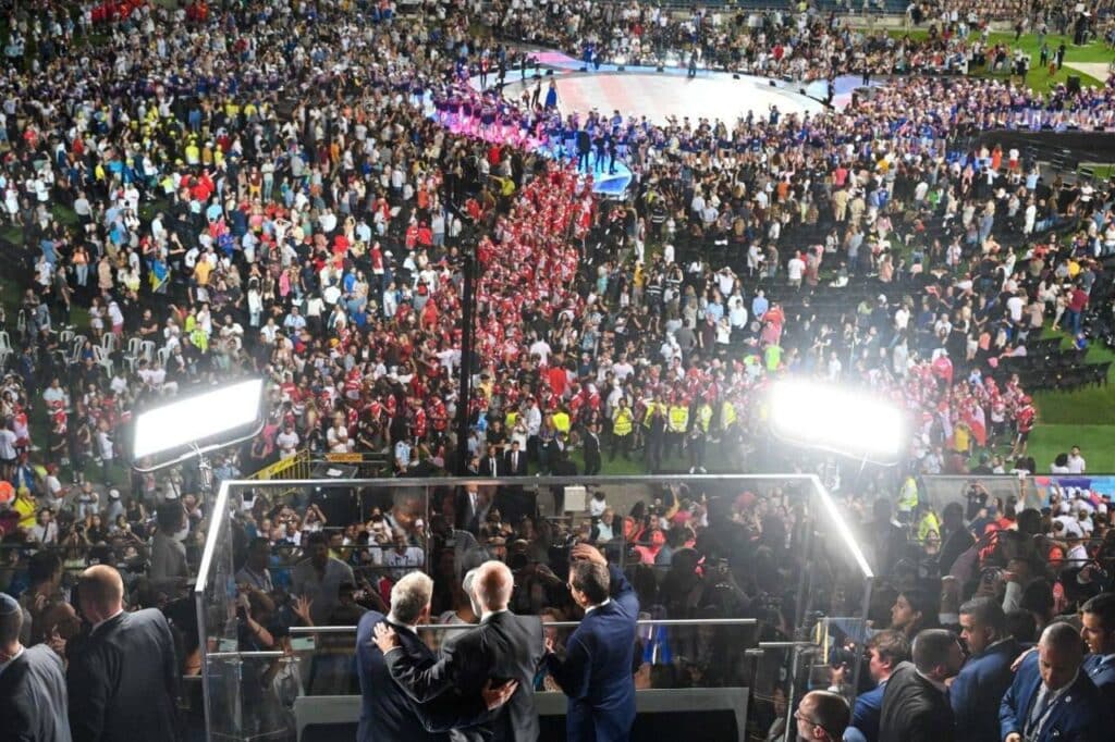 U.S. President Joe Biden (C), Israel's President Isaac Herzog (R) and Israeli Prime Minister Yair Lapid (L) greet the crowd at the opening ceremony of the Maccabiah Games in Jerusalem, on July 14, 2022