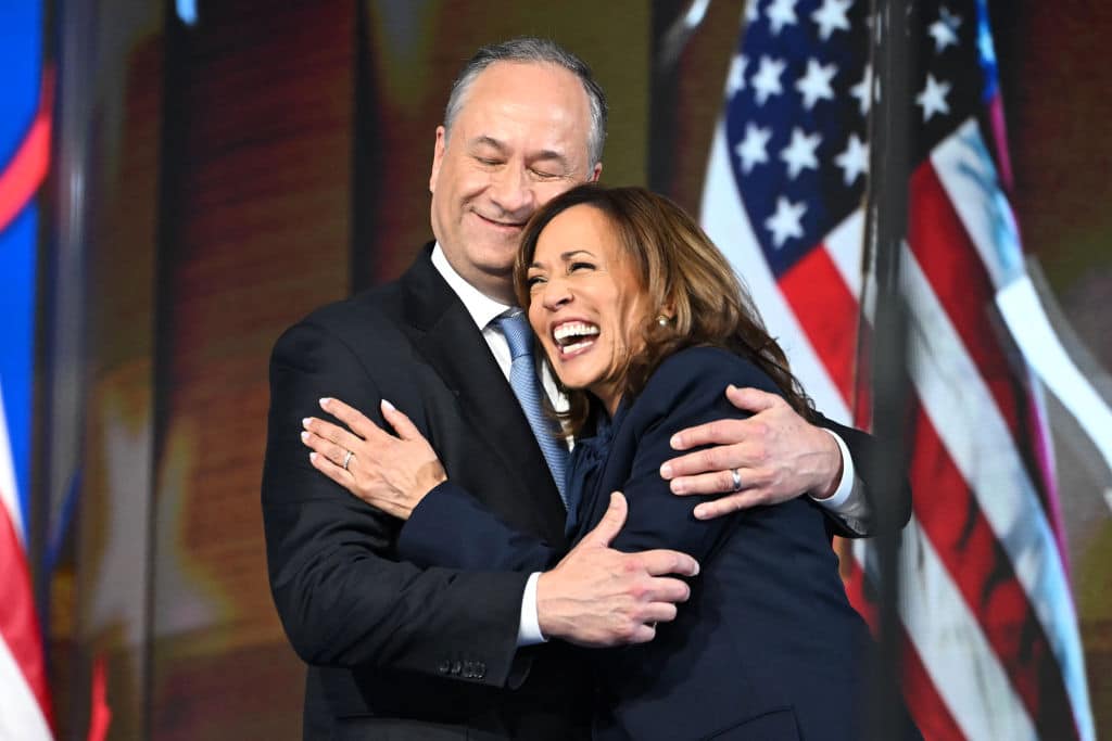 TOPSHOT - US Second Gentleman Douglas Emhoff (L) hugs US Vice President and 2024 Democratic presidential candidate Kamala Harris after speaking on the fourth and last day of the Democratic National Convention (DNC) at the United Center in Chicago, Illinois, on August 22, 2024. Vice President Kamala Harris will formally accept the party's nomination for president today at the DNC which ran from August 19-22 in Chicago. (Photo by ANDREW CABALLERO-REYNOLDS / AFP) (Photo by ANDREW CABALLERO-REYNOLDS/AFP via Getty Images)