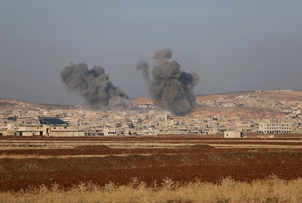 Smoke billows the the Syrian town of Suran, between Aleppo and Hama, on December 3, 2024. Islamist-led rebels advanced on December 3, on Syria's fourth-largest city Hama, buoyed by their lightning capture of swathes of the north in an offensive that ended four years of relative calm. Syrian state media reported that the two air forces had bombed the rebels in their Idlib stronghold as well as their vanguard in Hama province (Photo by Bakr ALKASEM / AFP) (Photo by BAKR ALKASEM/AFP via Getty Images)