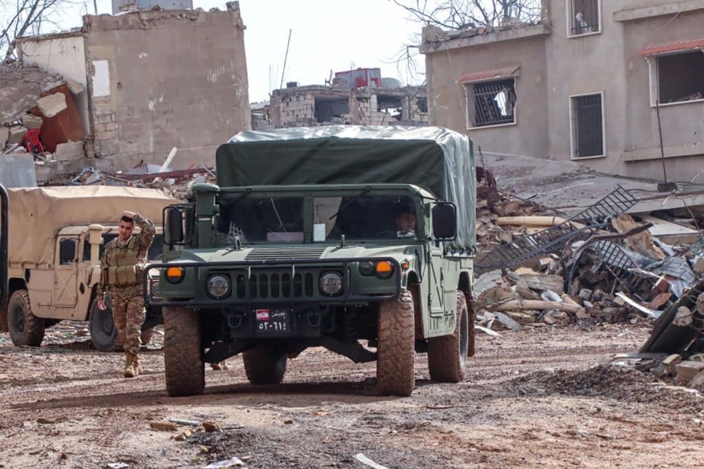 Lebanese soldiers drive in the southern Lebanese village of Khiam on December 23, 2024, after the withdrawal of Israeli forces from the area under a ceasefire deal with Hezbollah.