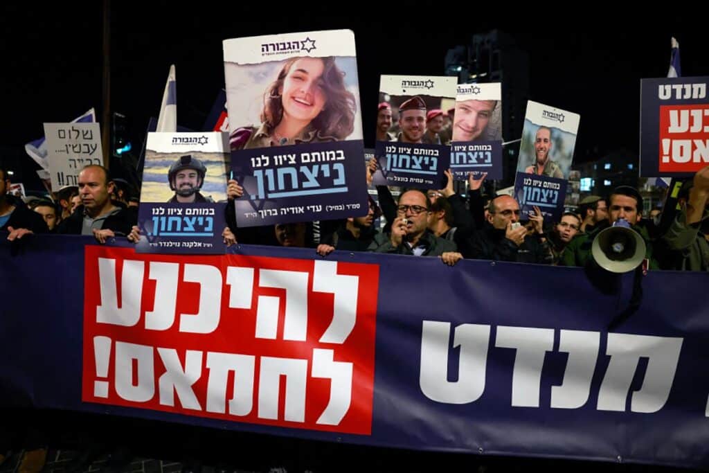 Right wing Israelis hold images of fallen soldiers during a march in Jerusalem rejecting a potential deal with Hamas, on January 13, 2025.