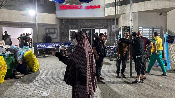 People stand outside the emergency ward of Al-Shifa Hospital in Gaza City on November 10, 2023, amid the war between Israel and Hamas. (Photo by -/AFP via Getty Images)