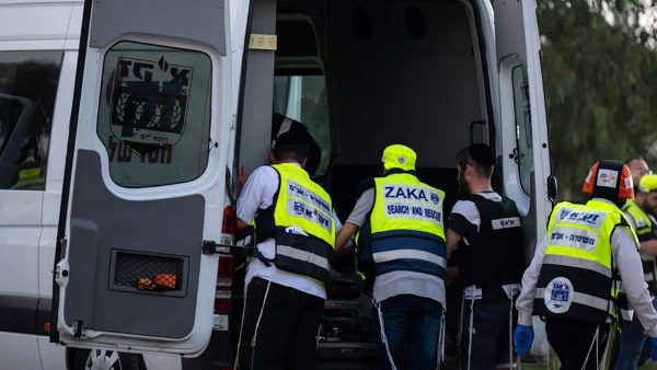 Members of Zaka remove a civilian killed days earlier after Hamas terrorists attacked Kibbutz Kfar Aza on October 10, 2023. (Photo by Alexi Rosenfeld/Getty Images)