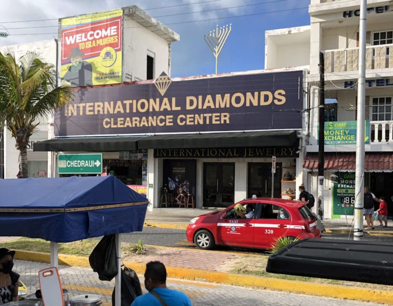 A menorah and a poster of the Rebbe greets ferry passengers outside of the terminal on Isla Mujares, Mexico.